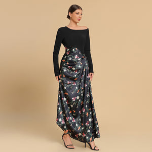 Woman wearing a black top and floral skirt on a beige background